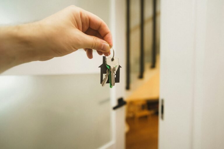 Keys being handed over at the door of a home